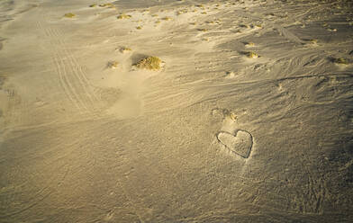 Spanien, Kanarische Inseln, Fuerteventura, Luftaufnahme der Herzform aus Steinen am Sandstrand Playa de Cofete bei Sonnenuntergang - CVF01704