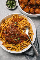 Spaghetti marinara with a side dish of meatballs - CAVF93893