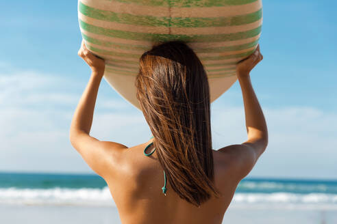 Surfer girl holding a surf board - CAVF93895