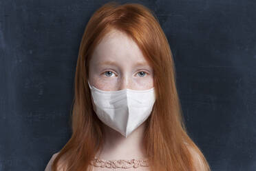 Girl with protective face mask against black background - GAF00148