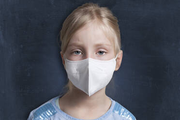 Girl wearing protective face mask against black background - GAF00162
