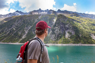 Mature man looking away by lake at Zillergrund, Austria - GAF00179