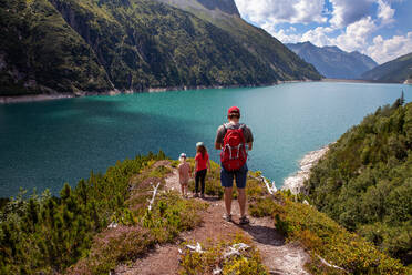 Man with daughters hiking on mountain at Zillertral, Austria - GAF00180