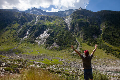 Mature man with arms raised standing at Zillertal, Austria - GAF00192