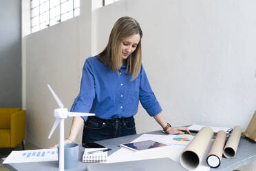 Businesswoman with document and digital tablet at office - GIOF12469