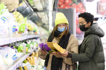 Freundinnen beim Einkaufen im Supermarkt während COVID-19 - VYF00590