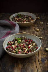 Two bowls of vegan quinoa salad with cashews, pomegranate seeds and mint - LVF09142