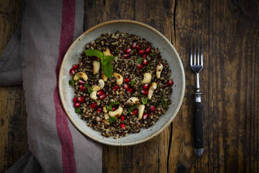 Bowl of vegan quinoa salad with cashews, pomegranate seeds and mint - LVF09144