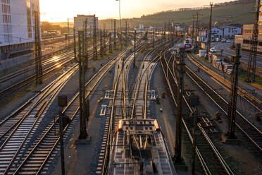 Germany, Bavaria, Wurzburg, Empty railroad tracks at sunset - NDF01272