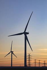 Germany, North Rhine Westphalia, Niederaussem, Wind turbines at sunset - JATF01306