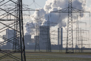 Germany, North Rhine Westphalia, Niederaussem, Electricity pylons near lignite power station - JATF01315