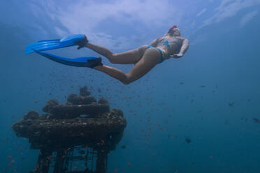 Young woman diving near underwater temple in Java Sea - TOVF00247