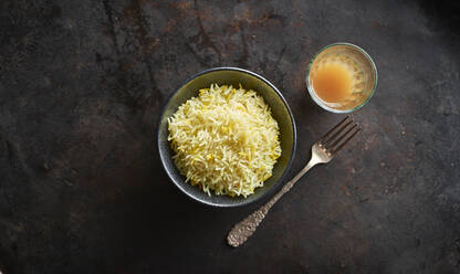 Studio shot of bowl of basmati rice. single fork and glass of chai tea - KSWF02208