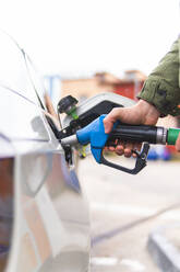 Young man refueling car at gas station - JAQF00499