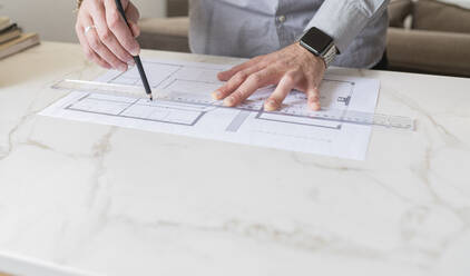 Man making construction plan on desk - JCCMF01944