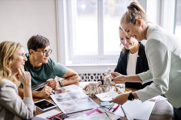 Smiling customers and event planners discussing at office - DAWF01923