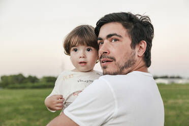 Father carrying son while looking away - FLMF00406