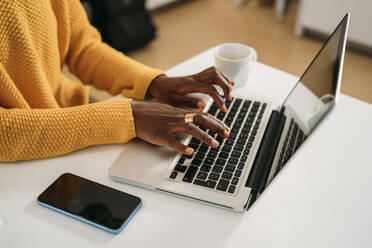 Young woman typing while using laptop at home - MPPF01673