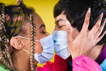 Young couple with protective face mask kissing each other - OIPF00494