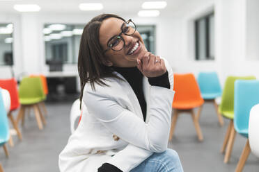 Happy female professional with hand on chin in education training class - JAQF00566