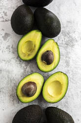 Studio shot of halved and whole avocados - GIOF12517