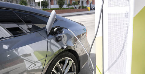 Car refueling at electric vehicle charging station - JCCMF02000