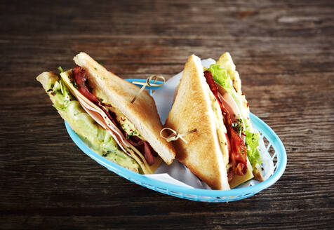 Studio shot of two sandwiches with ham, bacon, cheese and lettuce - KSWF02228