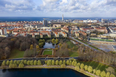 Sweden, Scania, Malmo, Aerial view of Pildammsparken in autumn with residential buildings in background - TAMF02943