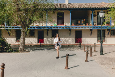 Tourist walking at village on sunny day - MRRF01084