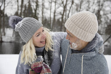 Happy woman embracing man during winter - FVDF00113