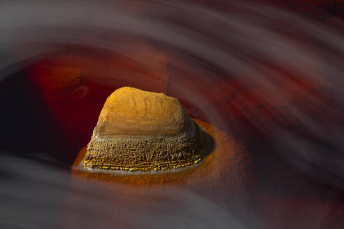 Majestic view of orange rock in river with fast flow in long exposure in Minas de Rio tinto - ADSF23484