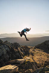 Male athlete running on mountain - RSGF00658