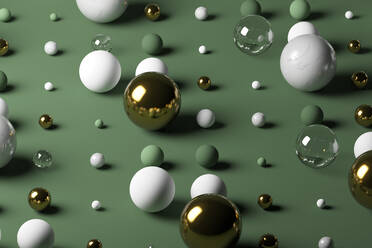 Gold, glass, marble spheres against pastel green background - JPSF00144