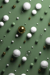 Gold, glass, marble spheres against pastel green background - JPSF00145