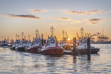 Germany, Hamburg, Boats moored in Neumuhlen at sunset in winter - KEBF01889