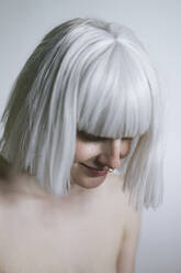 Shirtless woman with white hair looking down - AFVF08725