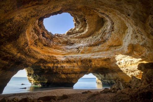 Scenic view of Benagil Cave with holes on shore against endless ocean in Algarve Portugal - ADSF23787