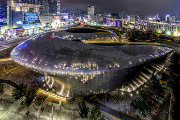 South Korea - JUNE 28, 2018:Glowing Dongdaemun Design Plaza with bronze figure landmarks in central district of Seoul and popular tourist destinations - ADSF23790