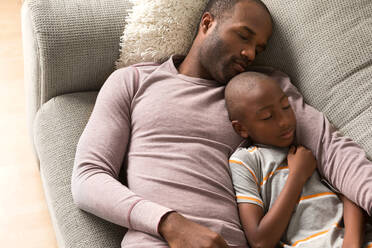 Father and son sleeping on sofa - ISF24508