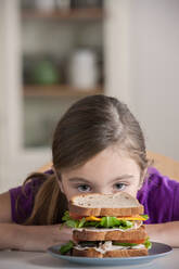 Girl staring at sandwich - ISF24514