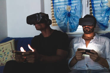 Men using virtual reality headsets with smart phones - ISF24595