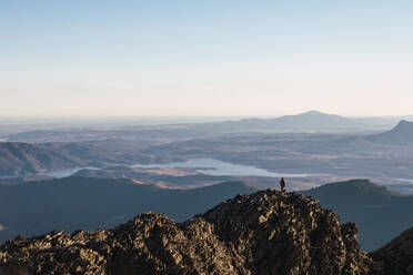 Man standing on mountain peak during vacations - RSGF00674