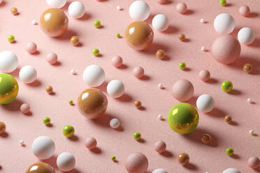 Three dimensional pattern of various spheres flat laid against pink background - JPSF00173