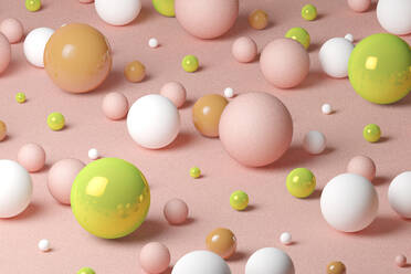 Three dimensional pattern of various spheres flat laid against pink background - JPSF00176