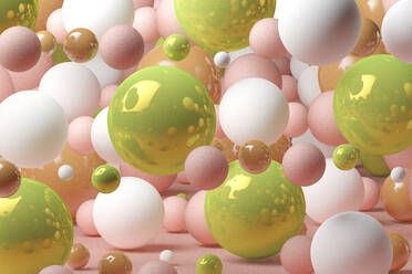 Three dimensional render of various spheres floating against pink background - JPSF00177