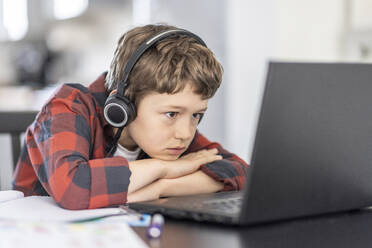 Boy attending online classes through laptop while e-learning at home - WPEF04372