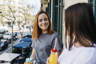 Smiling young woman looking at girlfriend - XLGF01763