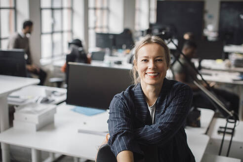 Portrait of businesswoman smiling at office - MASF23161