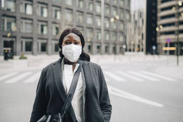 Portrait of female entrepreneur on street in city during COVID-19 - MASF23588