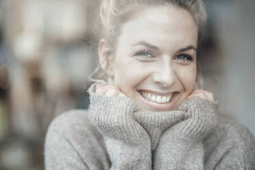 Mid adult woman wearing sweater smiling with hand on chin - JOSEF04394